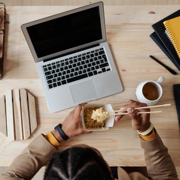 woman eating food at laptop