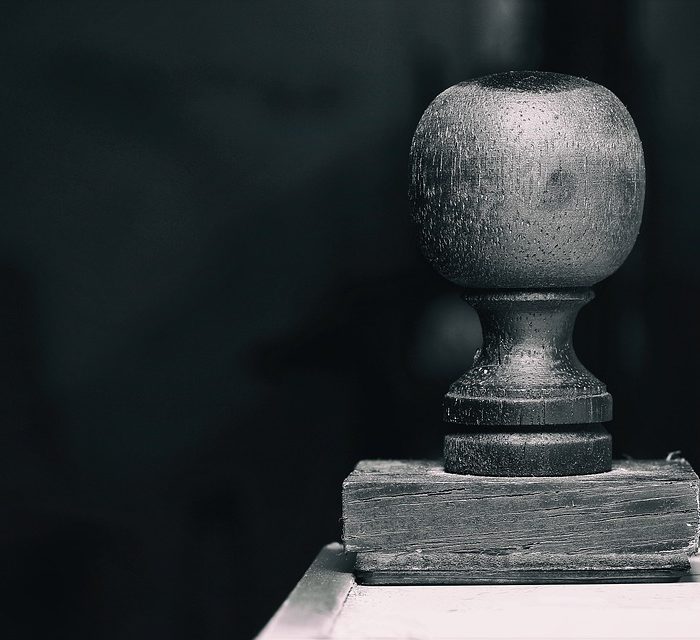 a stamp on desk with dark background