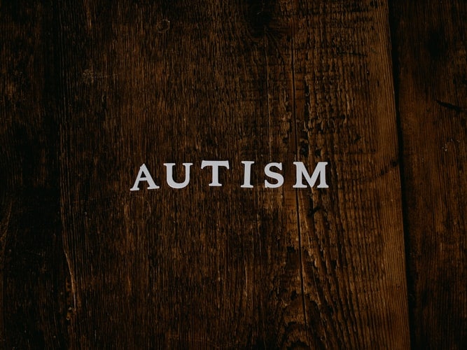autism written on table with block letters