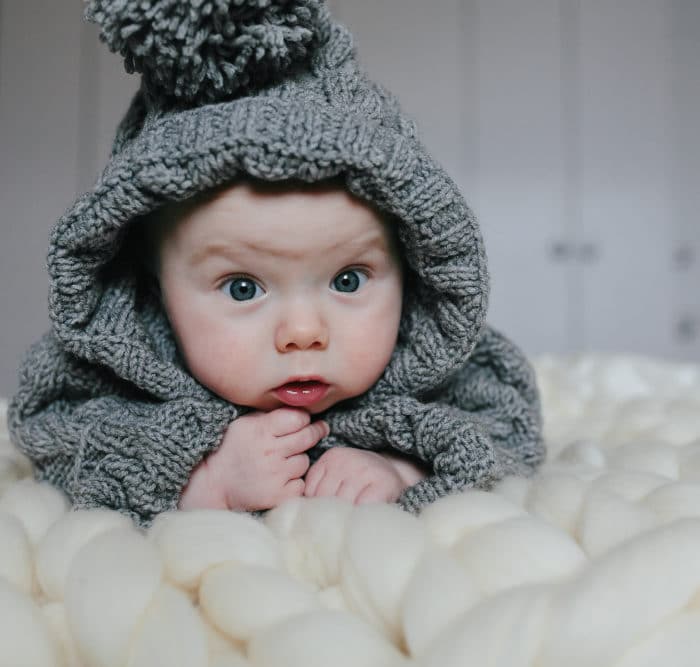 baby on knitted blanket