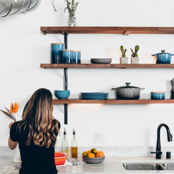 organized kitchen woman adjusting flowers