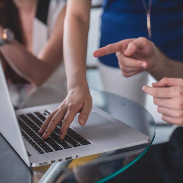 people pointing at computer