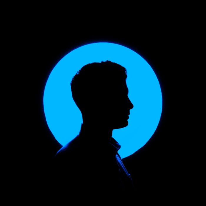 profile of man in blue circle