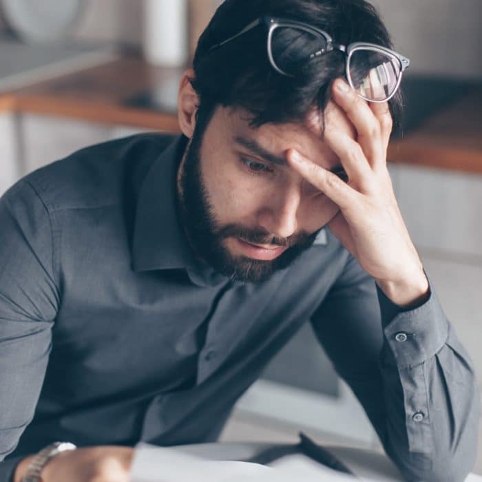 stressed man looking at paper