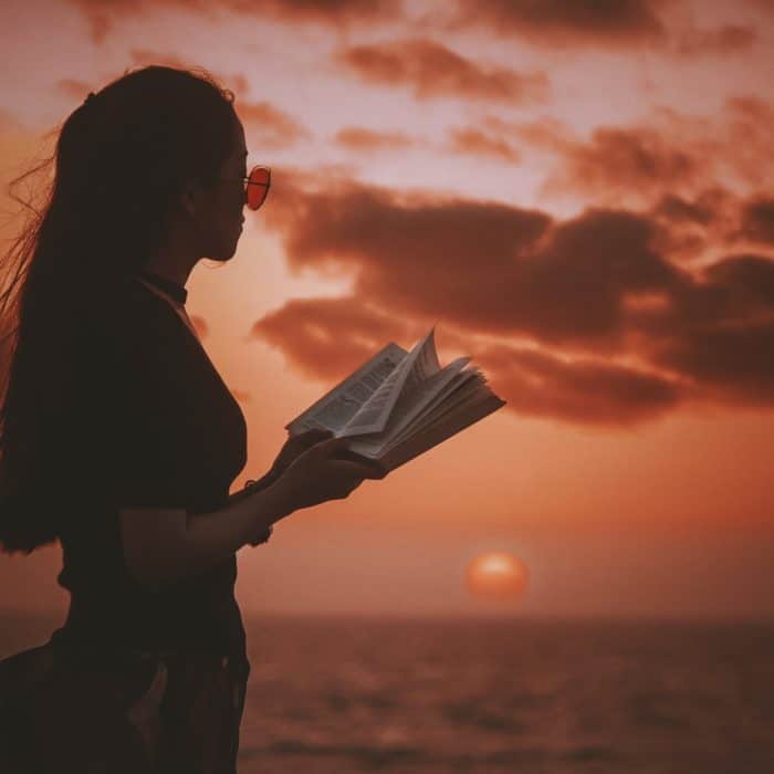 woman at beach with book