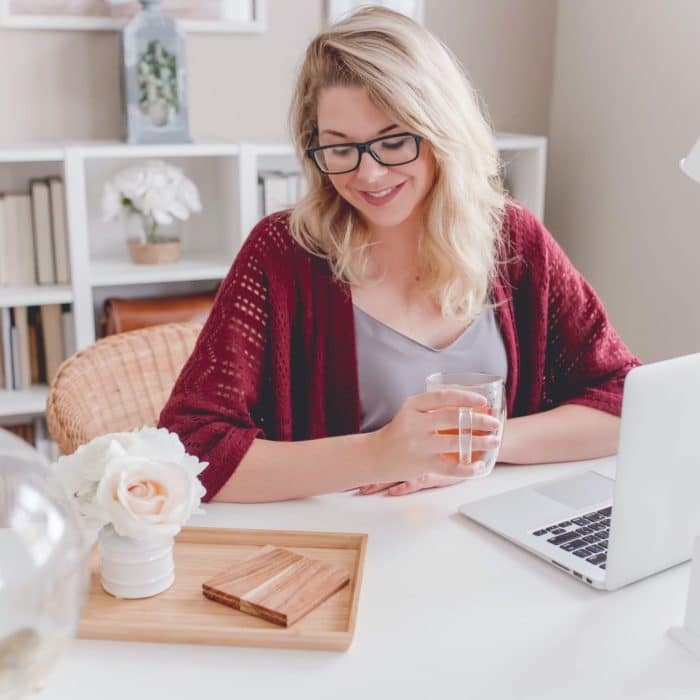 woman at laptop with tea