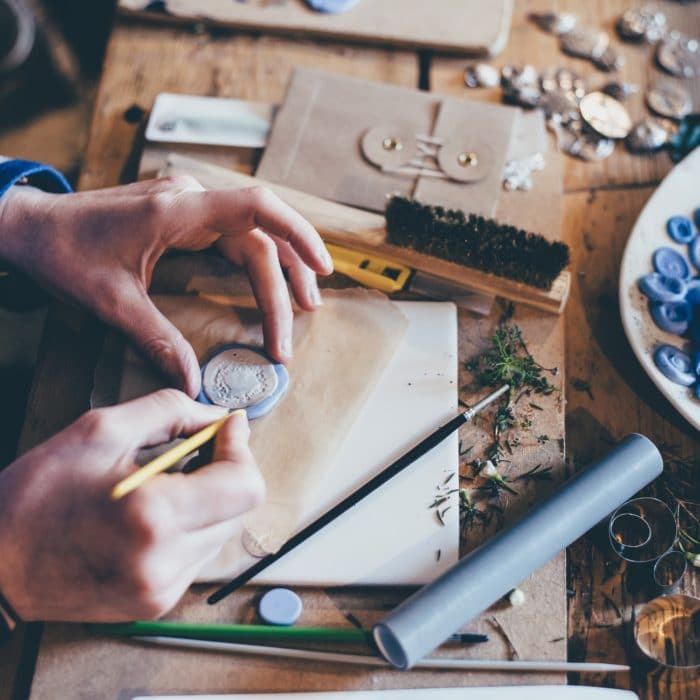 woman crafting buttons