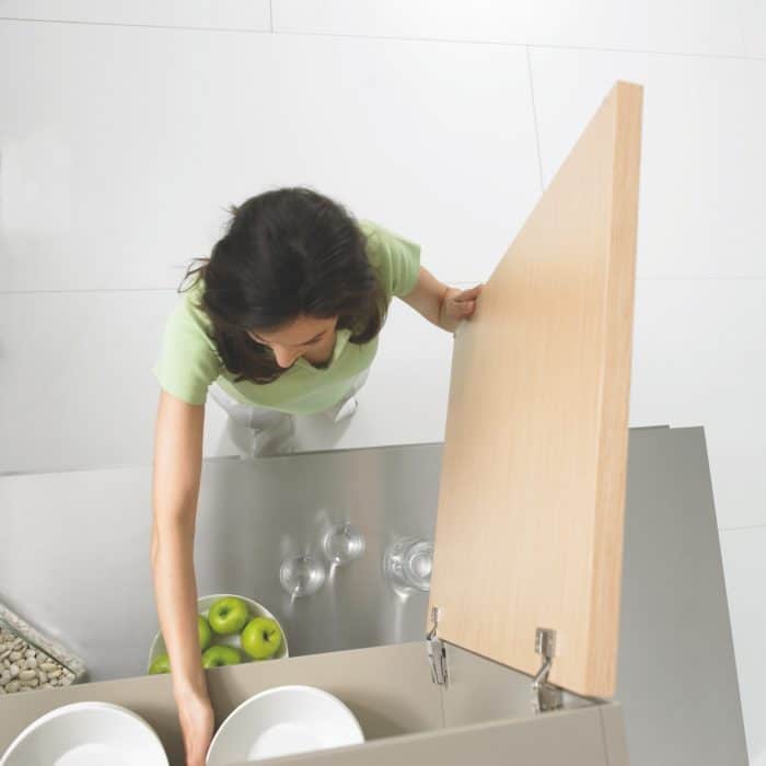 woman grabbing dishes from cupboard