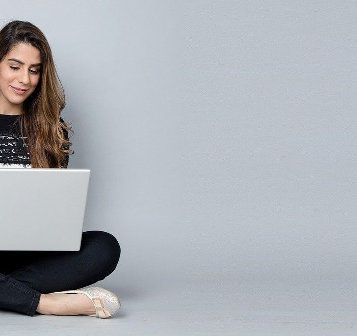 woman happy working on laptop