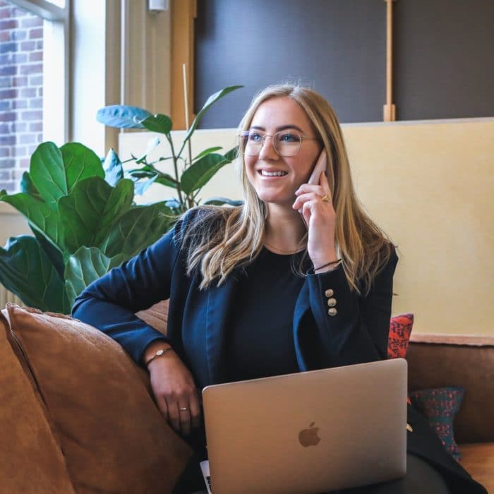 woman on laptop and on phone