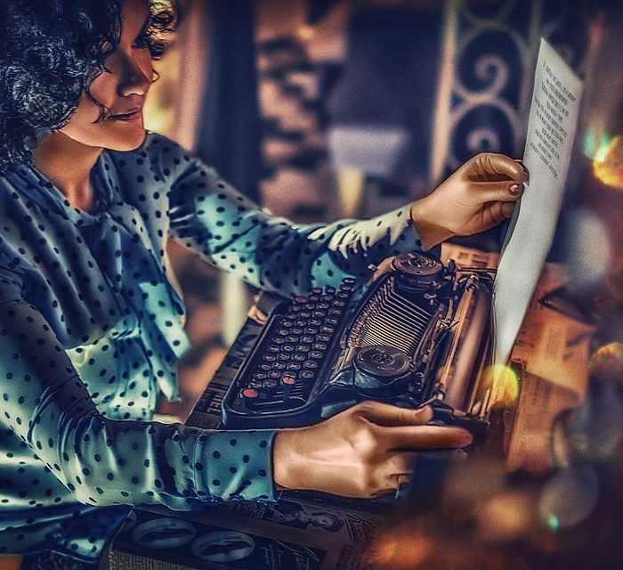 woman typing on typewriter