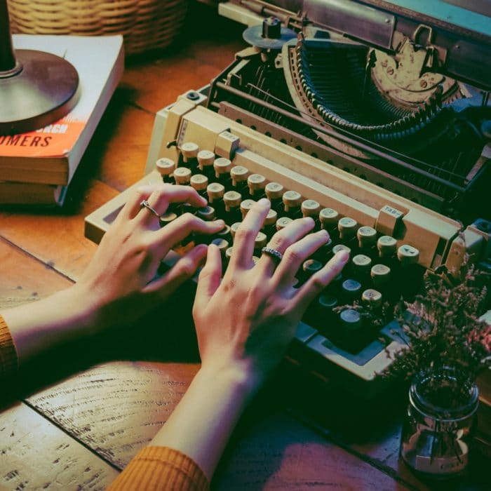 woman typing on typewriter