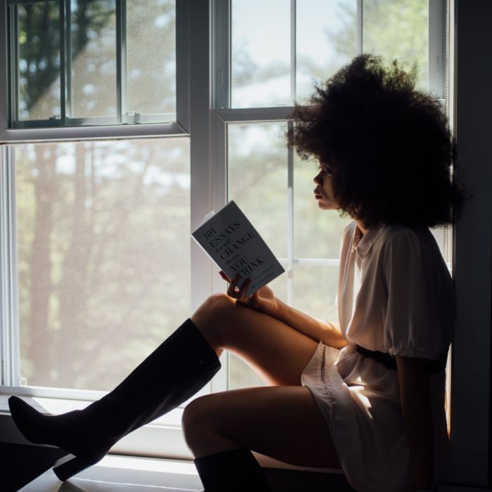 woman with book in windowsill