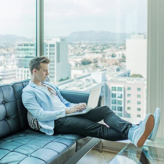 man on laptop in penthouse