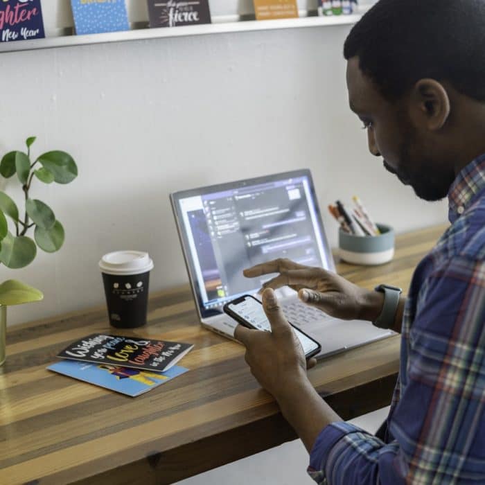 man on mobile and laptop