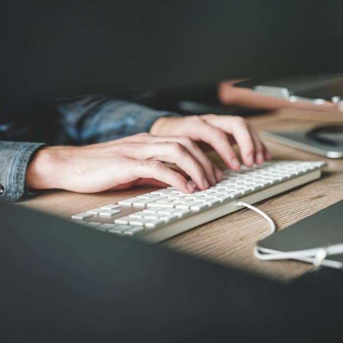 person typing on keyboard