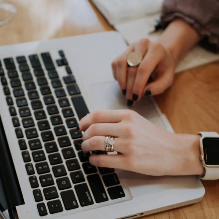 woman with rings typing