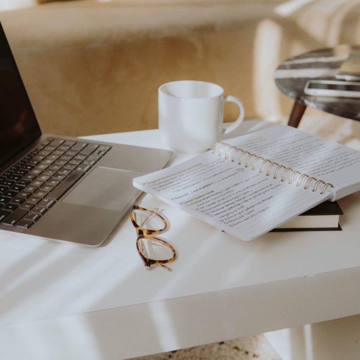 table with notebook and laptop